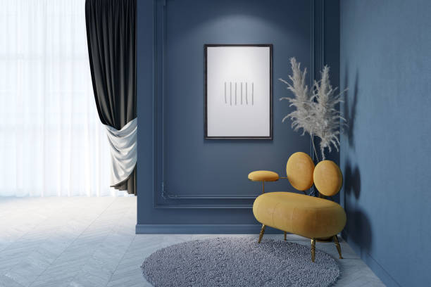 istock Dark classic interior with an illuminated vertical poster on a blue wall with moldings, feathers behind an original orange sofa, a round carpet on a parquet floor, curtains in the background. 1454102809