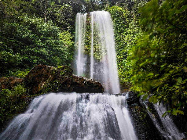 istock landscape long exposure of beautiful waterfall in forest 1454103776