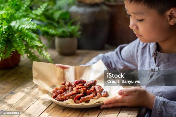 A Cute Little Boy Was Tasting Delicious Barbecue Stock Photo - Download Image Now - 6-7 Years, Barbecue - Meal, Barbecue Grill