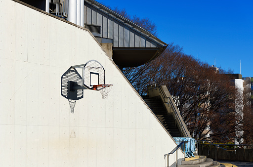 Basketball hoop on a white concrete wall with copy space.
