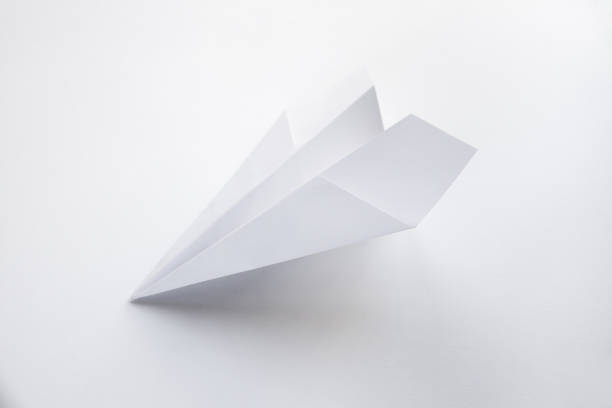 istock Paper plane origami isolated on a white background 1454112008