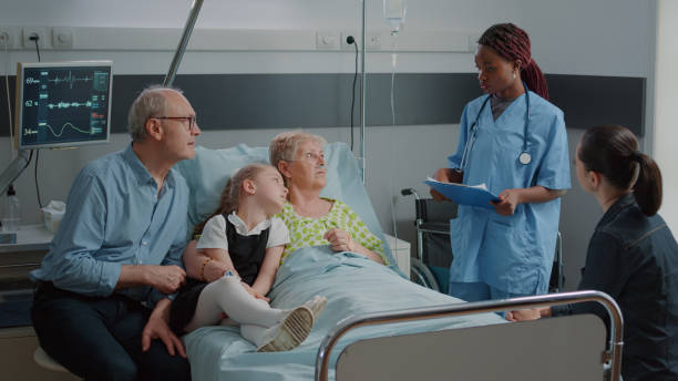 istock Nurse doing consultation with sick woman while family visits her 1454113318