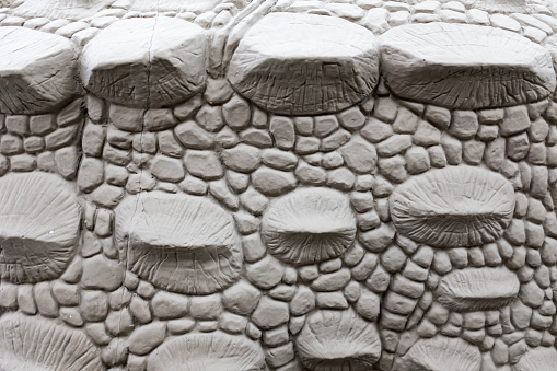 Partial detail of the scales of the artificial dinosaur clay sculpture