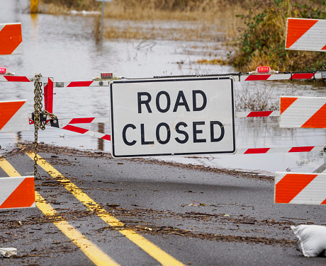Road Closed Sign on Flooded Road Chained Barricade
