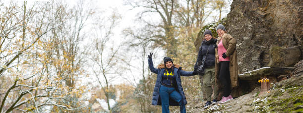 istock Three ladies pose cheerfully for a portrait outdoors in a snowy day 1454121713