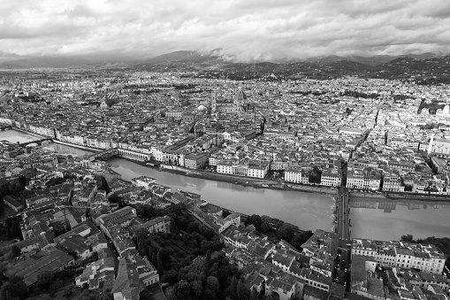A grayscale bird's eye view of Lyon cityscape with the Rhone river and traditional buildings in Europe