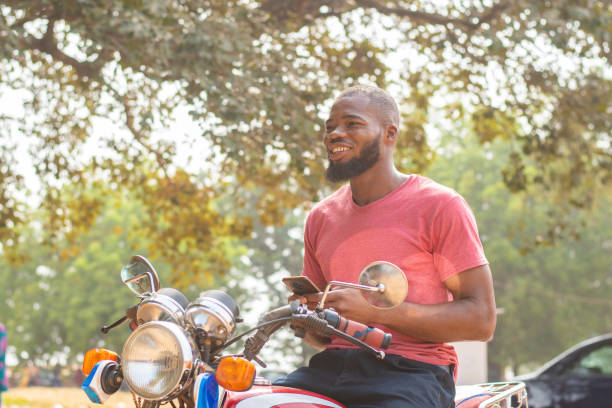 istock Black man on a motorcycle with a smartphone 1454123225