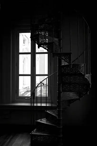 Photo of Black and white silhouette of Victorian era wrought cast iron spiral staircase, Singapore