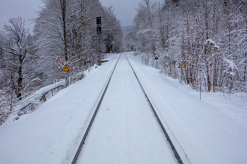 snow covered railroad through the bavarian forest
