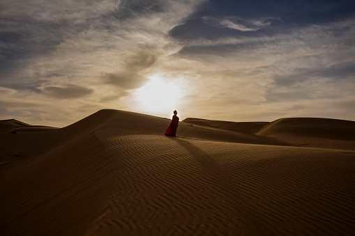 Desert Photography during sunset, Senior model wearing Arabic Dress, Rub'al Khali, Abu Dhabi, United Arab Emirates