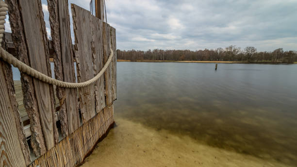 istock Wall with a rope leading into the silver lake, Germany, Lower Saxony, Hanover, Langenhagen 1454127070