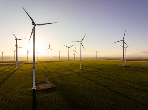 Aerial view of wind turbines with fields in evening light