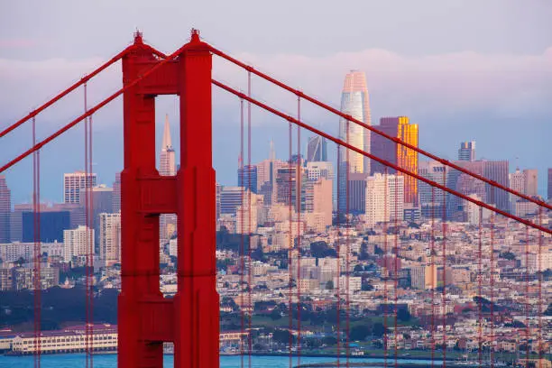 The Golden Gate Bridge tower with San Francisco cityscape in the background in California