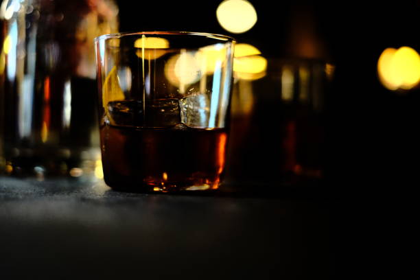 istock Glass of drink on dark background 1454128695