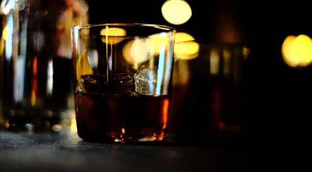 istock Glass of drink on dark background 1454128870