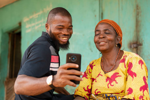 istock Young black male teaching his older mother how to use technology 1454130077