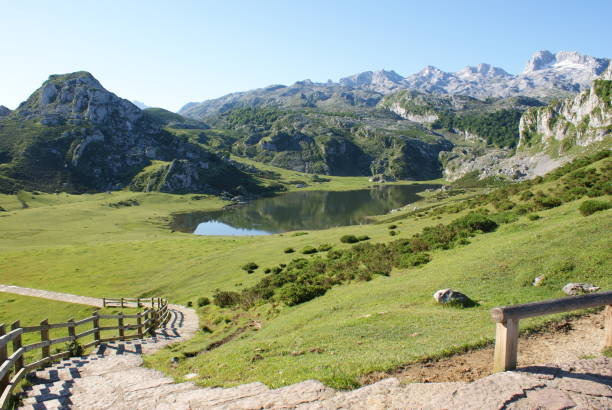 istock Of small pond surrounded with hills and mountain valley 1454130764