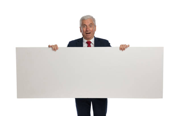 old businessman feeling shocked and holding billboard