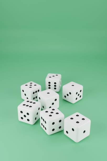 istock Vertical closeup shot of white playing dice on a green background 1454131282