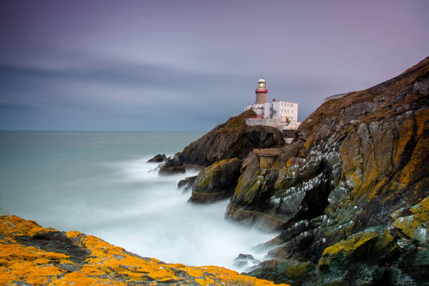 istock Daylight begins yielding to twilight, The Baily Lighthouse at sunset on Howth Head 1454131443
