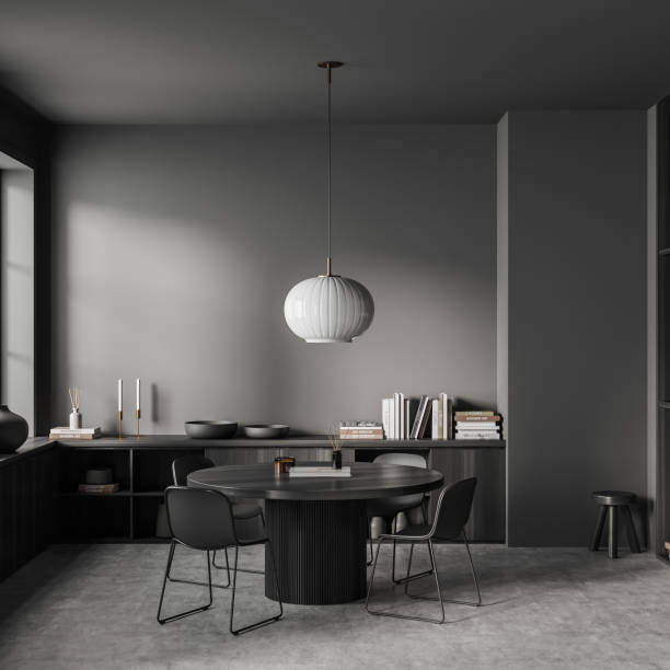 istock Grey living room interior with eating table and chairs, drawer and decor 1454131833