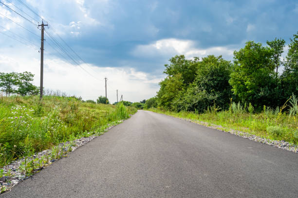 istock Beautiful empty asphalt road in countryside on colored background 1454132561