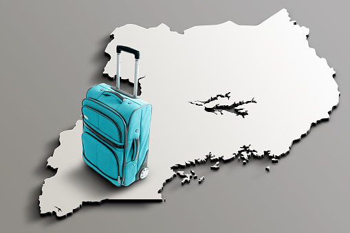 Blue suitcase on blank 3d map of Uganda. Copy space. No people. Horizontal orientation.