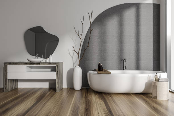istock Stylish bathroom interior with sink and bathtub, decor and window 1454133465