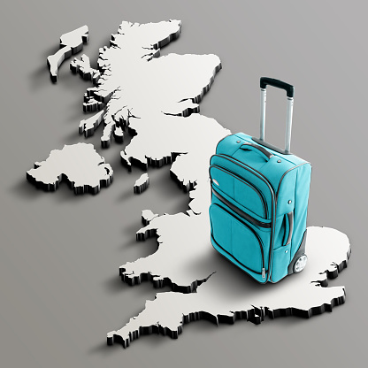 Blue suitcase on blank 3d map of Great Britain. Copy space. No people. Horizontal orientation.