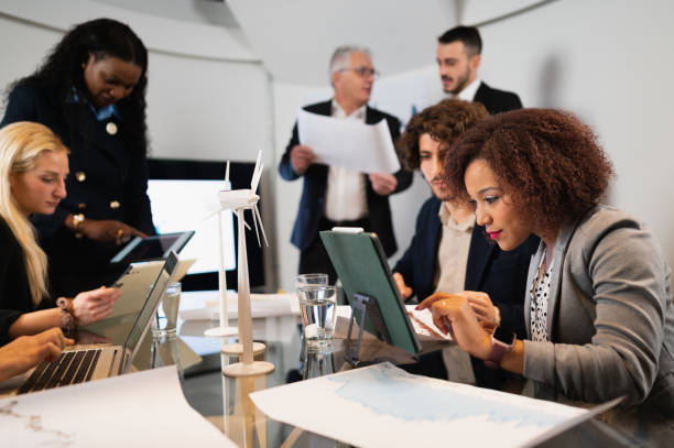 istock Group of work with diverse ethnicity sitting at desk in workplace. 1454134153