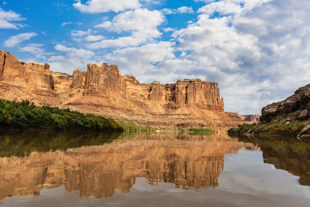 istock Huge rocks and reflection on a river against a cloudy sky 1454135084