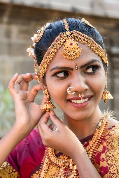 istock classical dancer express the smile and adjusting a earrings. 1454135364