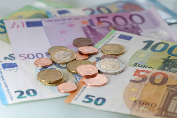 istock Euro coins on Euro banknotes 1454136010
