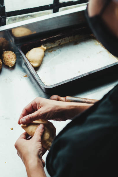 istock Vertical shot of a cook forming pastry in a kitchen 1454136517