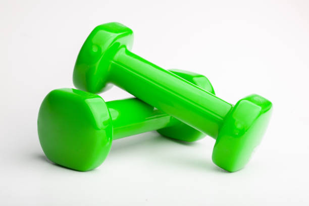 istock Closeup shot of green dumbells isoalted on a white backgound 1454137314
