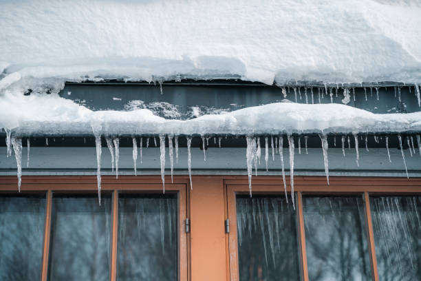 istock Icicles hanging in front of a house window during winter 1454139351