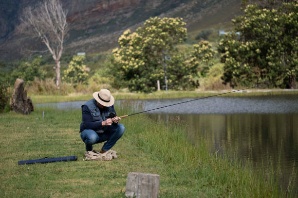 istock Fisherman catching fish in the river 1454139500