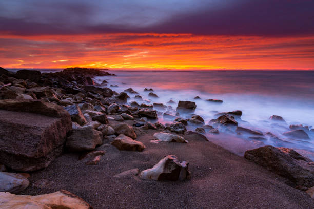istock Seashore of the tranquil sea under a sunset sky 1454140225