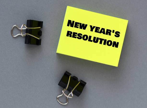 istock New year's resolution words on a small piece of paper. 1454140879