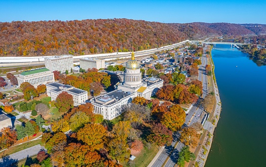 An aerial view of the West Virginia State Capitol Building and downtown Charleston with fall foliage