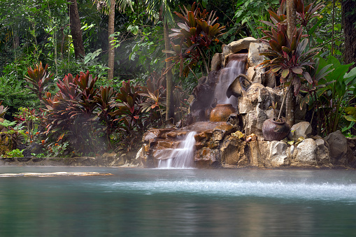 landscape view of manmade waterfalls and a pool of natural ot spring water