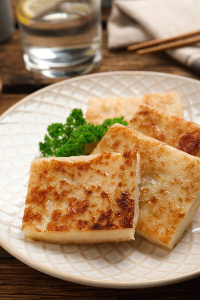 istock Delicious turnip cake with parsley served on wooden table 1454145813