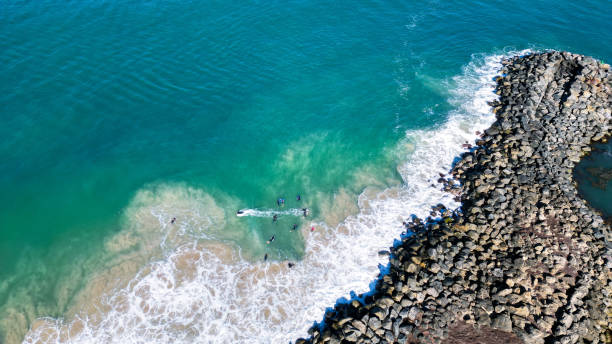 Waves Crashing On Rocks Crystal clear Australian ocean crashing against the rocky coastline groyne stock pictures, royalty-free photos & images