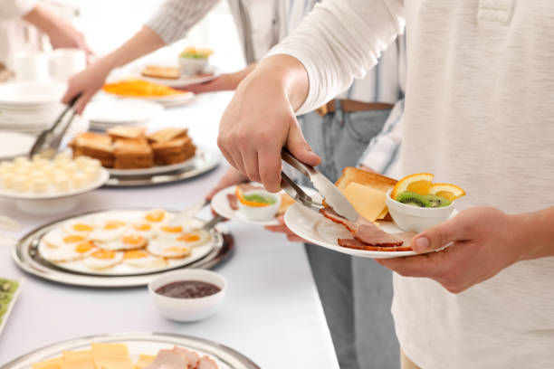 istock People taking food during breakfast, closeup. Buffet service 1454146278