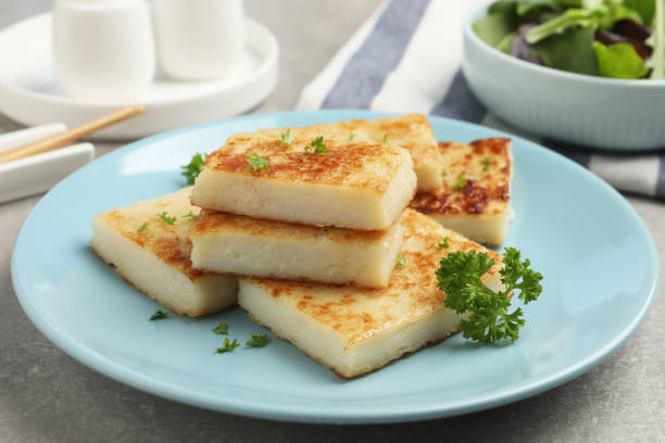 istock Delicious turnip cake with parsley served on grey table 1454147169