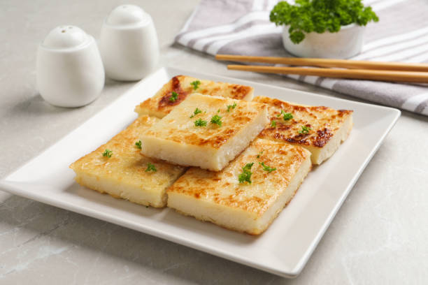 istock Delicious turnip cake with parsley served on light table 1454147297