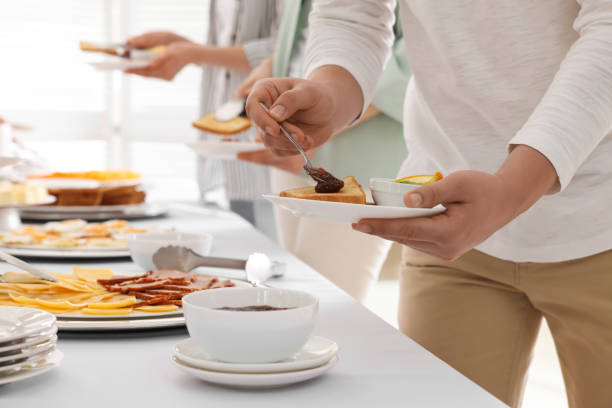 istock People near table with different dishes during breakfast, closeup. Buffet service 1454147426