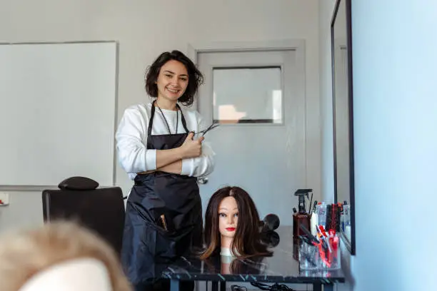 Photo of A Student working as a hairdresser with a dummy