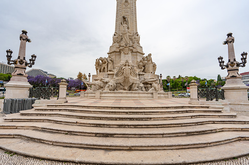 Marques de Pombal roundabout in the city of Lisbon with details of the stone statue