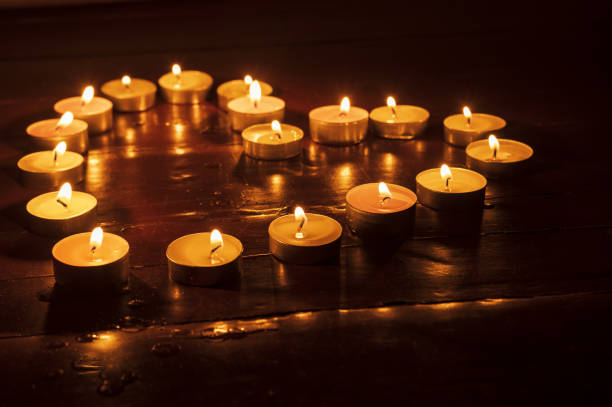 istock candles burning in the dark on the floor 1454151364